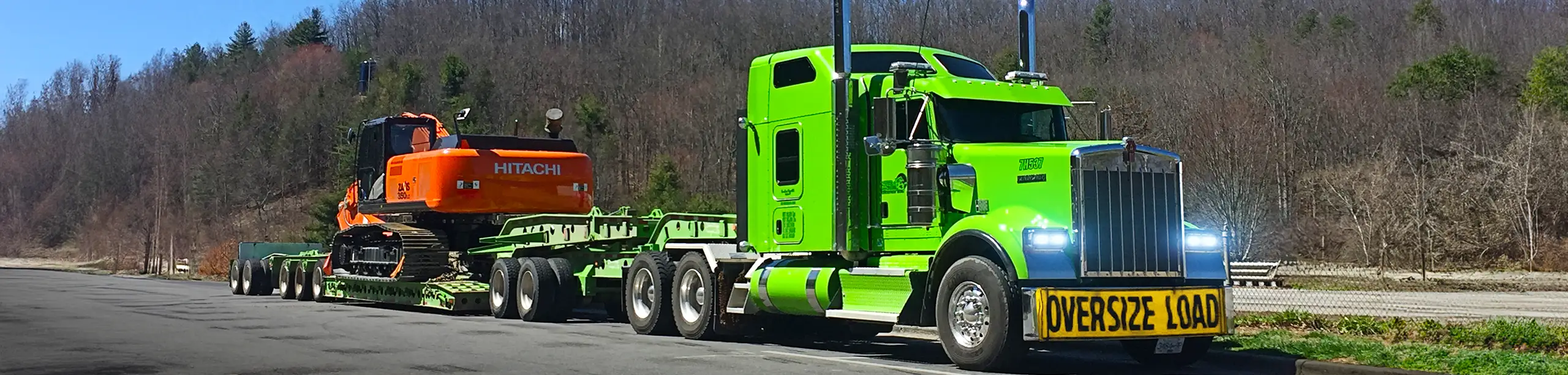 Seven Horses truck hauling oversized construction machinery on West Coast highway