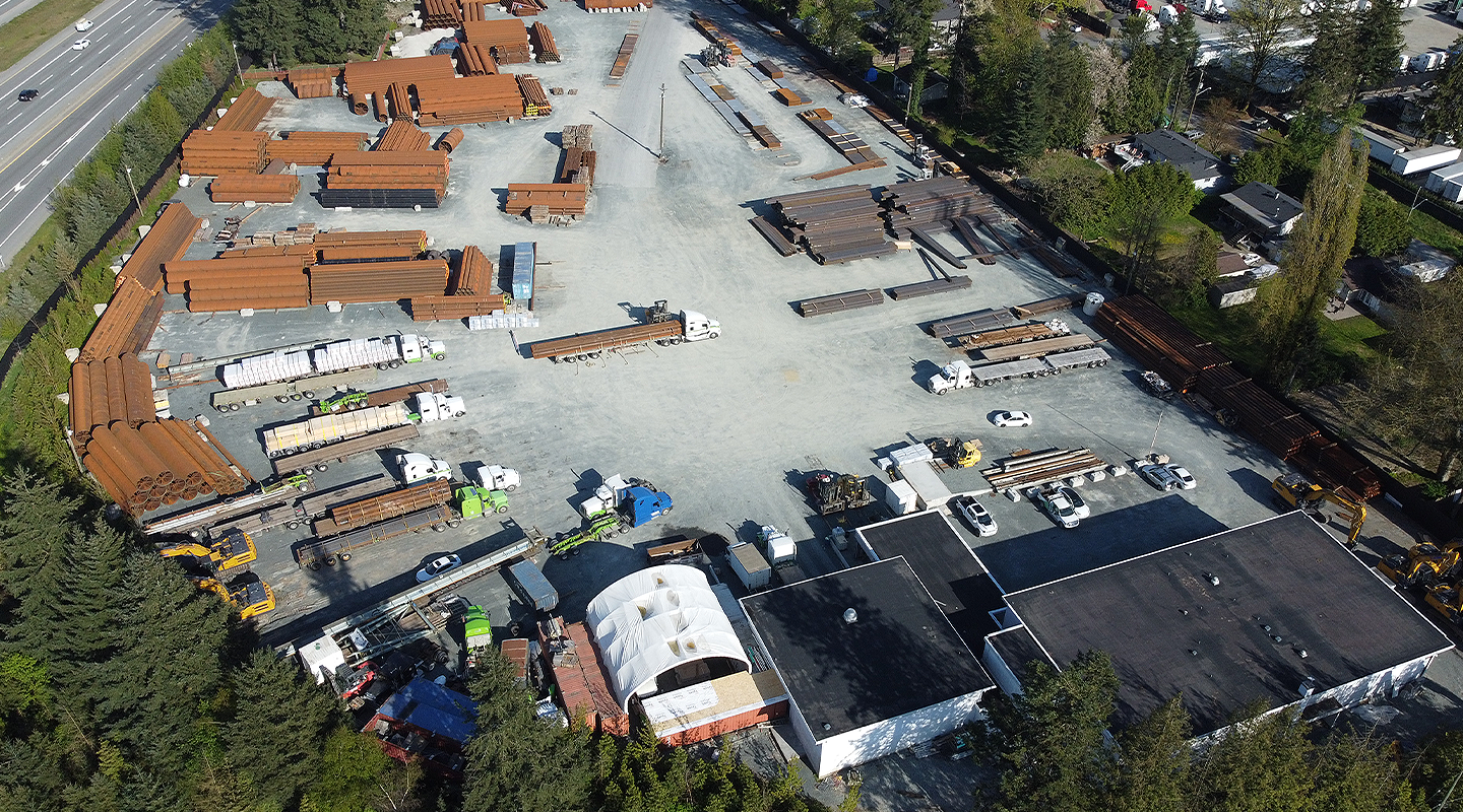 Overhead view of Seven Horses BC outdoor storage yard & warehousing facility with parked trucks and specialized freight