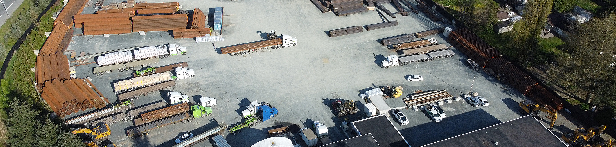 Overhead view of Seven Horses BC outdoor storage yard & warehousing facility with parked trucks and specialized freight